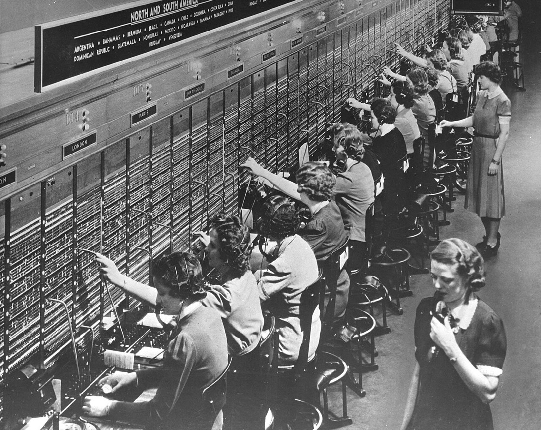 Rows of women working at a Bell System telephone switchboard
