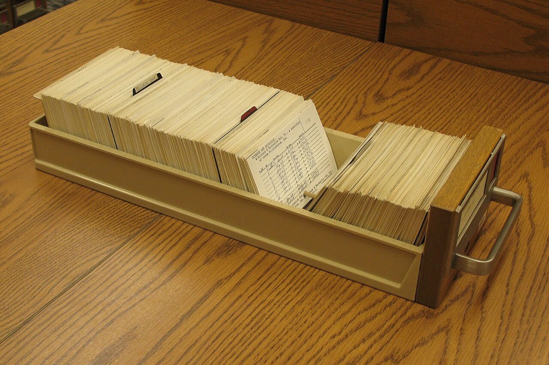 An open library card catalog drawer